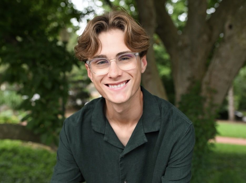 Joey smiling in a green shirt