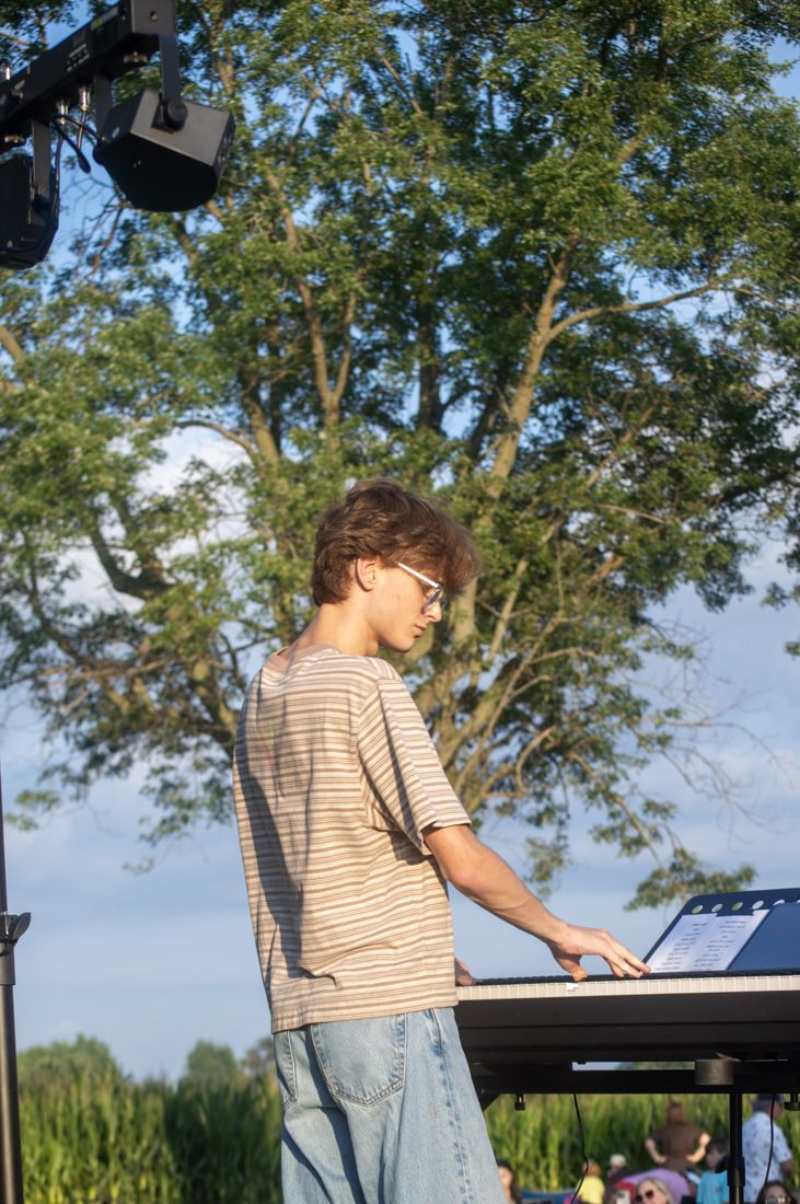 Joey playing keys at an outdoor show